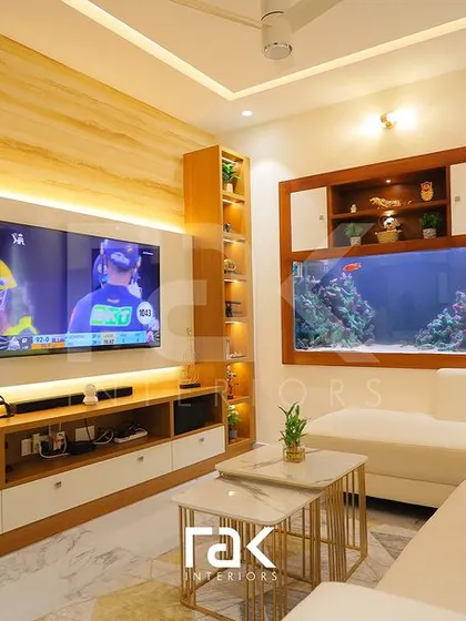A full view of the living area, showcasing the wood-paneled TV wall and integrated aquarium. The design balances natural elements with modern furniture for a fresh and lively family space.