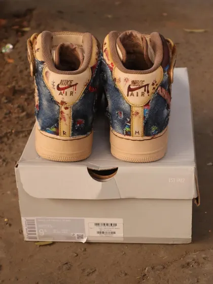 The back view of the Chucky AF1 Mids. I continued the denim dungaree and blood-spatter theme onto the heel, adding my initials "R" and "M" for a personal touch.