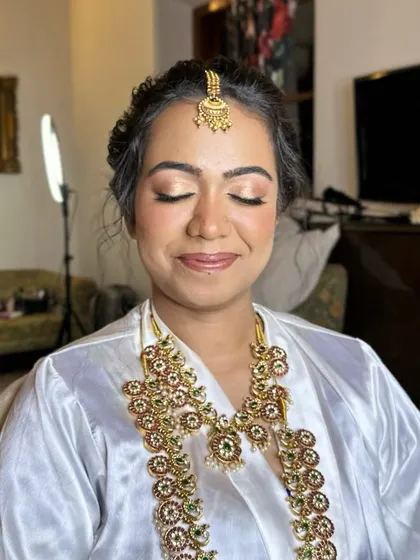 Getting ready in a robe, with the bridal jewellery already hinting at the grandeur to come. The makeup is soft and luminous, creating a perfect canvas for the final look.