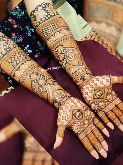 A complex and beautiful design with a mix of geometric shapes, floral bands, and traditional symbols.