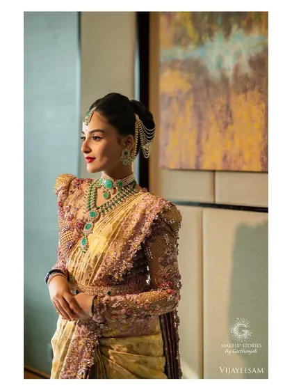 The complete royal look. Krishna's posture and the grandeur of her outfit are perfectly complemented by the powerful, regal makeup, making for a truly breathtaking bridal portrait.