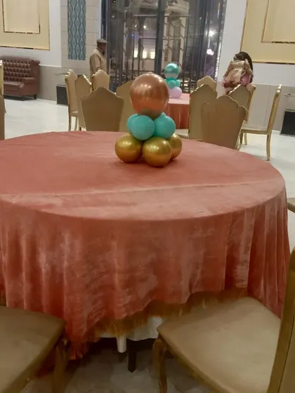 A simple yet elegant balloon centerpiece for guest tables. These small touches help carry the party's theme and colors throughout the venue.
