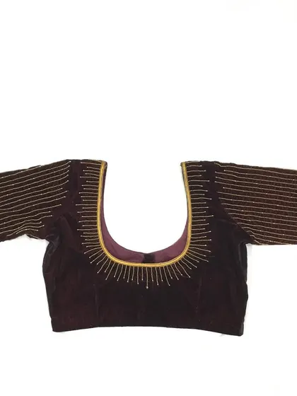 A simple yet elegant hand-worked blouse with lines of beads on a velvet base.