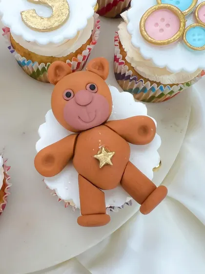 Look at this cute, handcrafted fondant teddy bear topper. It's these little details that make our custom cupcakes a memorable part of your celebration.