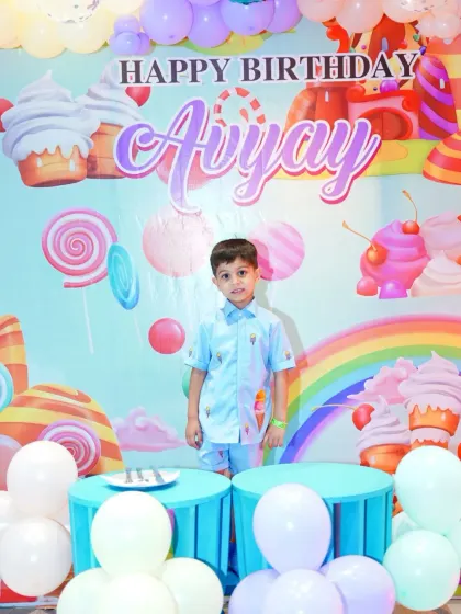 The birthday boy stands proudly in front of his personalized candy-land backdrop. We ensure the birthday star is the center of attention.