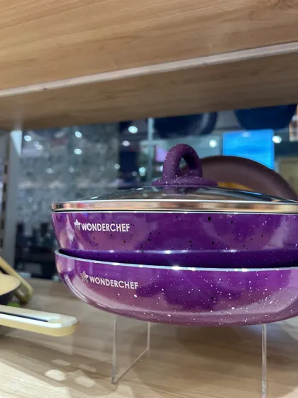 Clean, professional product shots are essential for e-commerce. This image for Wonderchef showcases their purple cookware set, using clear lighting and simple stacking to emphasize the product's design and color for online catalogs.