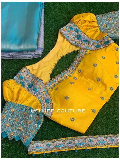 A flat-lay of the yellow and teal blouse set. This includes the blouse, the unstitched saree fabric, and an embroidered border, showing how all the components are designed to work together.