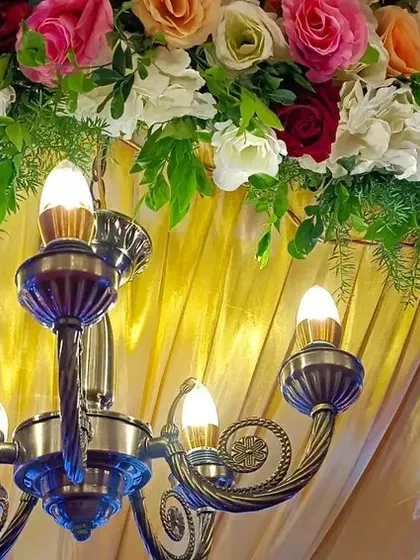 A close-up of the details. We often incorporate beautiful elements like this vintage-style chandelier into our stage designs to add warmth and elegance.