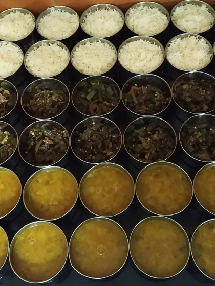 Preparing lunch orders for offices in Greater Noida. We ensure every meal, whether for home or office, is prepared with the same attention to hygiene and homemade taste. Here you can see bhindi sabzi, dal, and rice ready to be packed.