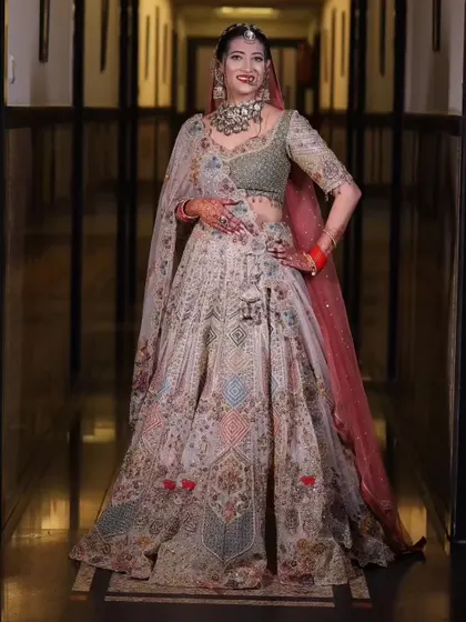 Another full-length shot of the bride, showing off the beautiful drape of her lehenga and her confident pose.