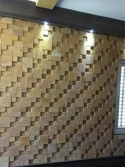 This 3D stone wall is a great example of how to add texture and depth to a space. The cubic pattern of the sandstone tiles creates a dynamic play of light and shadow, especially when highlighted by overhead spotlights.
