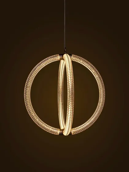 A close-up of the Luminora pendant against a dark background, its internal light source creating a warm and captivating glow.
