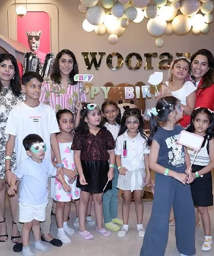 A group photo of all the guests and parents at a fun and glamorous kids' spa party.