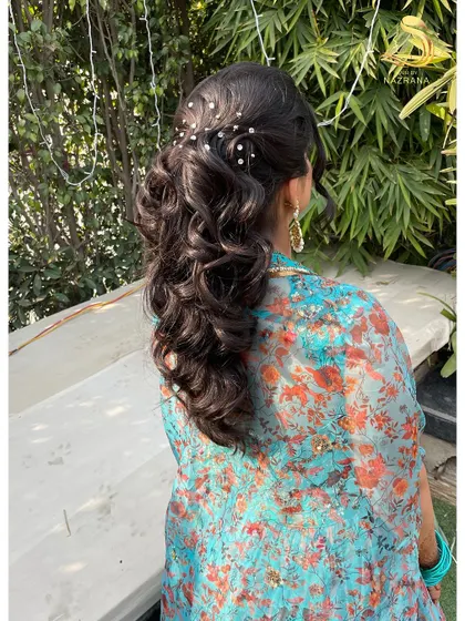 A beautiful outdoor shot of the pearl-accented ponytail, showing how it complements a floral outfit perfectly.