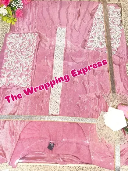 A lovely pink suit set, neatly arranged and packed in a display box with a simple floral touch.