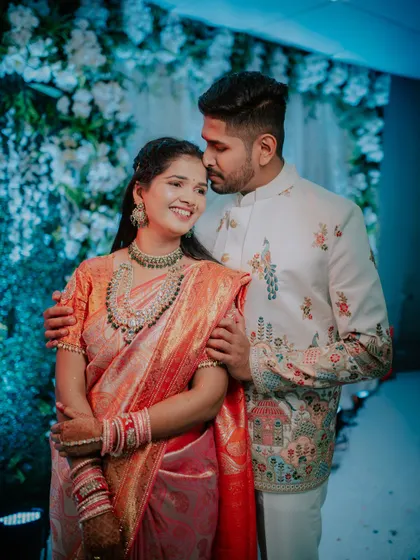 A sweet moment with the groom-to-be kissing his fiancée's forehead.