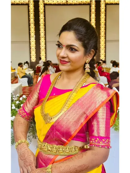 A closer look at the beautiful embroidery on the sleeve of the pink blouse, designed to match the richness of the silk saree.