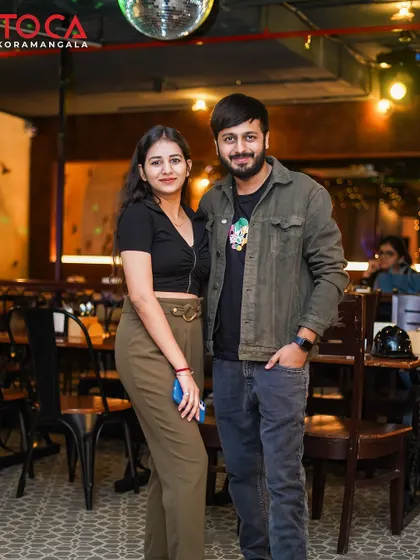 A couple enjoying a night out, with the music setting the perfect mood.