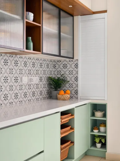 This view highlights the thoughtful storage solutions, including open corner shelves and pull-out wicker baskets.