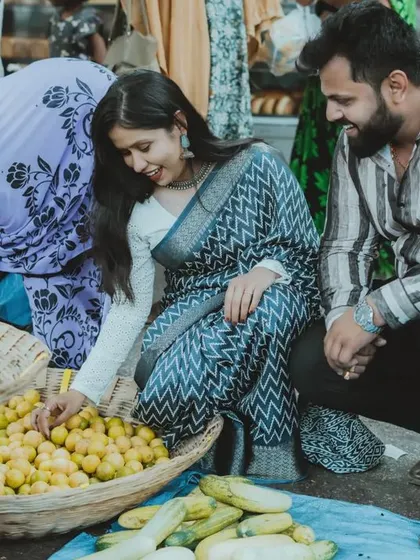 A candid moment of a couple sharing a smile while exploring a local market. This type of pre-wedding shoot is perfect for capturing authentic interactions.