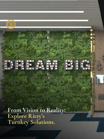 From vision to reality, explore our turnkey solutions. A "Dream Big" sign on a green wall in a corporate office, reflecting our ability to create inspiring commercial spaces.