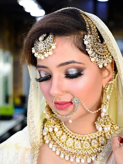 A close-up bridal portrait focusing on the stunning silver eye makeup and heavy kundan jewelry.