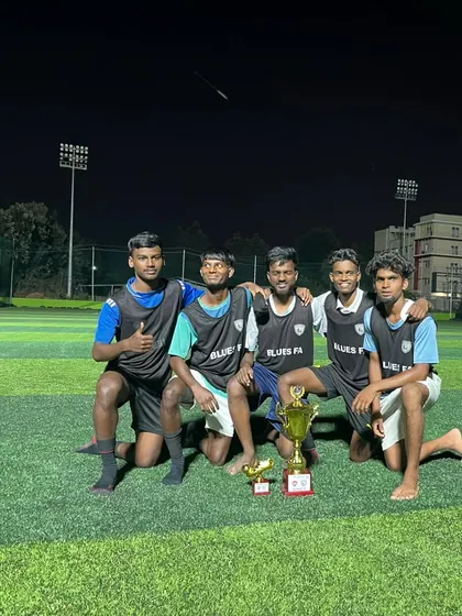 Our C-Division coaches and players celebrate with their trophy after a successful tournament, a proud moment for Head Coach Hari and the team.