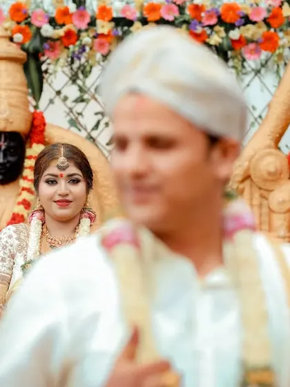 A beautiful candid shot of the bride looking towards her groom during the ceremony, with him softly out of focus in the foreground.