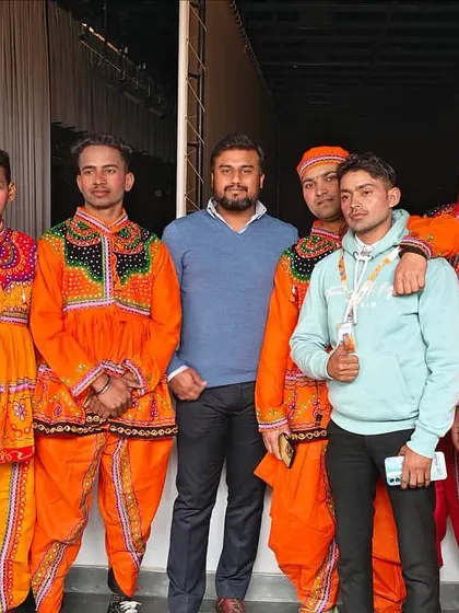 With another group of folk dancers in traditional Gujarati attire. I can incorporate cultural performances from various regions of India to suit your event's theme.
