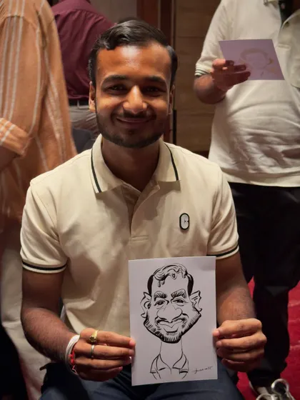 A happy guest proudly holding his finished black and white caricature. My quick sketches are designed to capture a likeness and personality in just a few minutes.