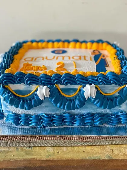 A vintage-style sheet cake for the 2nd anniversary of Anumati. I used their brand colors for the buttercream piping and included their logo and mascot for a personalized corporate celebration cake.