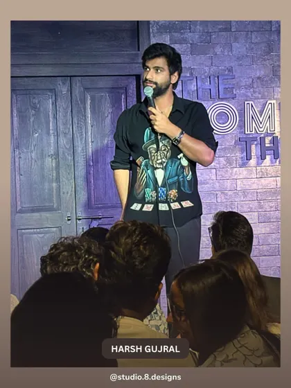 Harsh Gujral on stage at The Comedy Theatre. The dark, moody backdrop we designed helps keep the focus entirely on the performer, enhancing the stand-up comedy experience.
