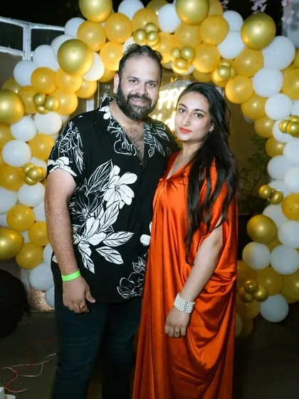 A couple posing for a photo at a birthday celebration. We also capture great photos of the guests and hosts at your party.