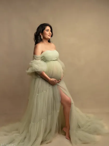 A vision in soft green. This gown, with its delicate layers and off-shoulder design, is one of my favorites for creating a romantic, garden-like feel in the studio.