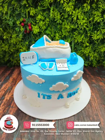 "It's a Boy!" A cute baby shower cake with a fondant baby in a bassinet. The blue and white cloud theme is perfect for welcoming a little prince.