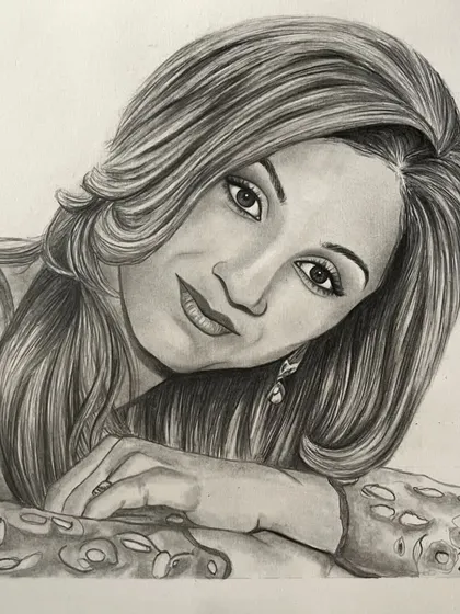 A completed A4 pencil portrait of a woman with flowing hair, based on a professional photograph. This sketch makes a sophisticated and personal piece of art.