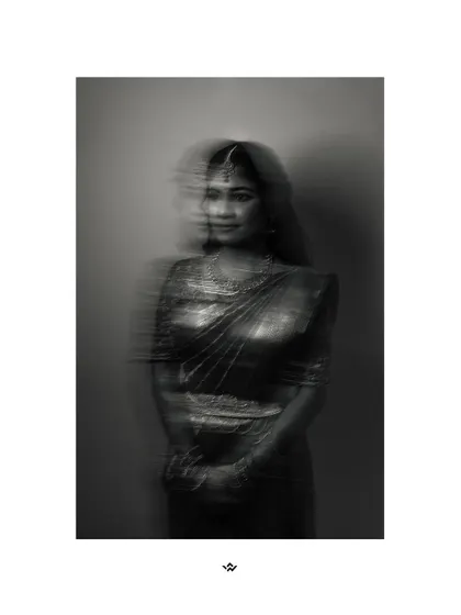 An artistic black and white portrait of the bride with a motion blur effect, creating a dreamy and ethereal look.