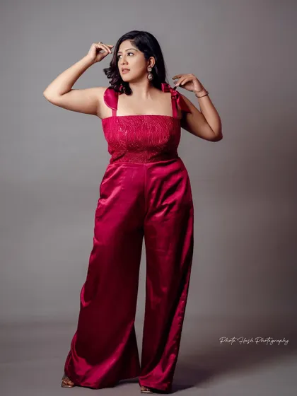 A full-length view of the chic and modern magenta jumpsuit.