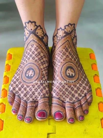 A modern take on bridal foot henna, with a central elephant mandala and a beautiful geometric net pattern covering the feet.