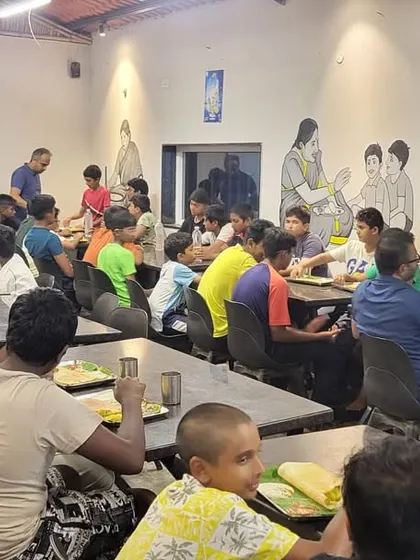 Players and parents enjoying a meal together, highlighting the community spirit of our tours.
