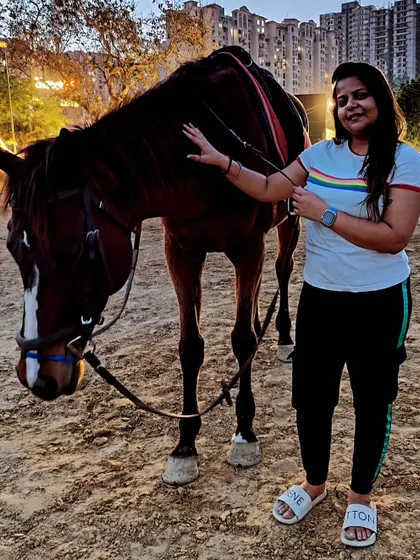 A visitor enjoying a quiet moment, connecting with one of our calm and gentle horses.
