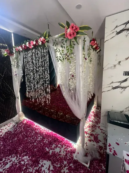 The complete wedding night room setup, creating a luxurious and romantic retreat for the couple with flowers and soft lighting.