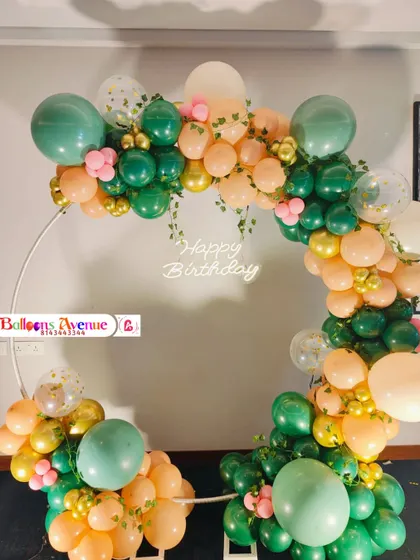 A clear, frontal shot of the elegant green and peach birthday ring.