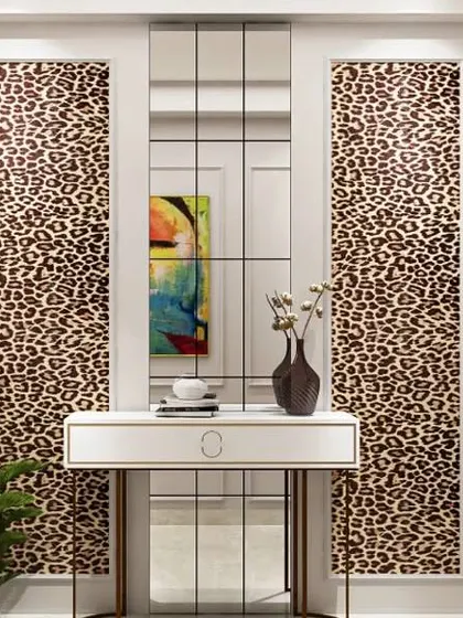 A bold and stylish foyer with animal print panels flanking a tall mirror. This design is perfect for someone who loves to make a statement with their decor.