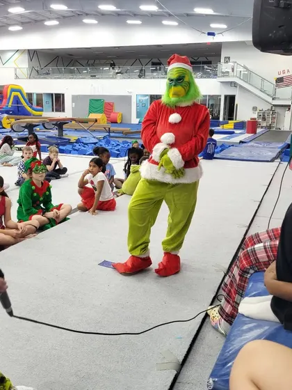 Another great shot of the Grinch entertaining the children. We go all out to bring our party themes to life for an immersive experience.
