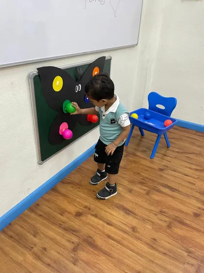 This child is deeply focused on the butterfly color matching activity. Such engaging tools help build concentration and reinforce learning in a playful manner.
