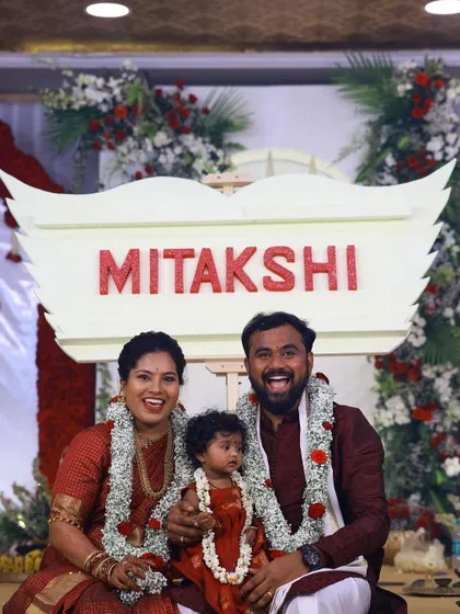 A beautiful family portrait captured after the name reveal. The joy on their faces is a testament to a perfectly executed celebration.
