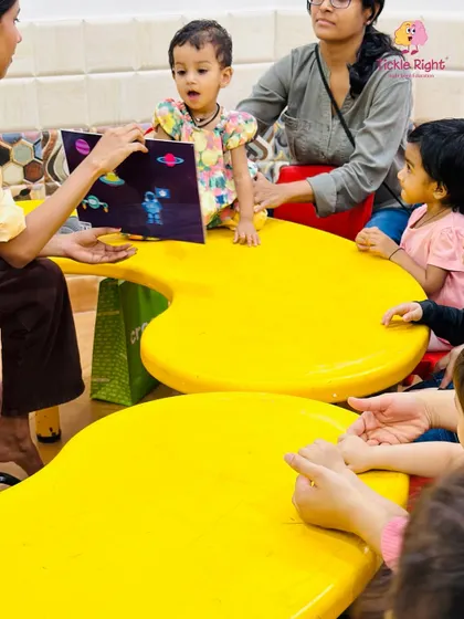 A child looks on with wide-eyed wonder during a flashcard session about space. We introduce a wide range of topics to expand their knowledge and spark their curiosity about the world.