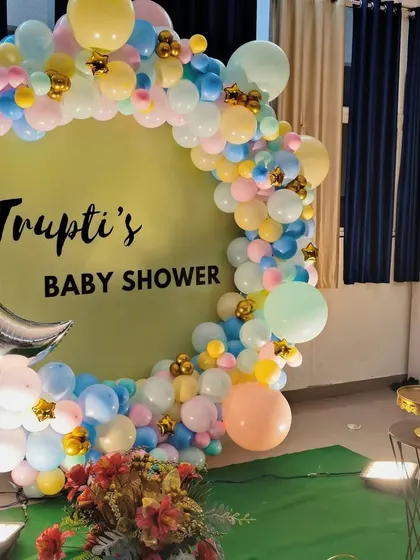 A closer view of the pastel themed baby shower backdrop, showing the mix of colors and the 'BABY' blocks in front.