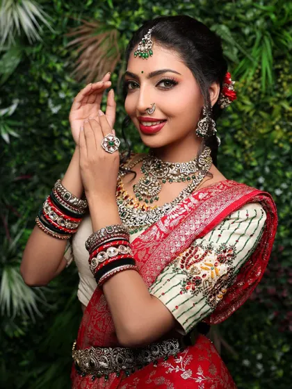 A playful and happy portrait of a model in a bridal look. Her clapping hands and bright smile create a sense of celebration and joy, perfect for a wedding theme.